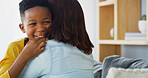 African child, love and hug mother in home for care, smile and family bonding together. Kid, mom and embrace boy in living room for connection, support and healthy relationship with single parent