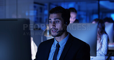 Buy stock photo Night, computer and businessman in call center with sales, consultant and answer at help desk. Virtual assistant, consulting or customer service agent with mic headset, online support and business