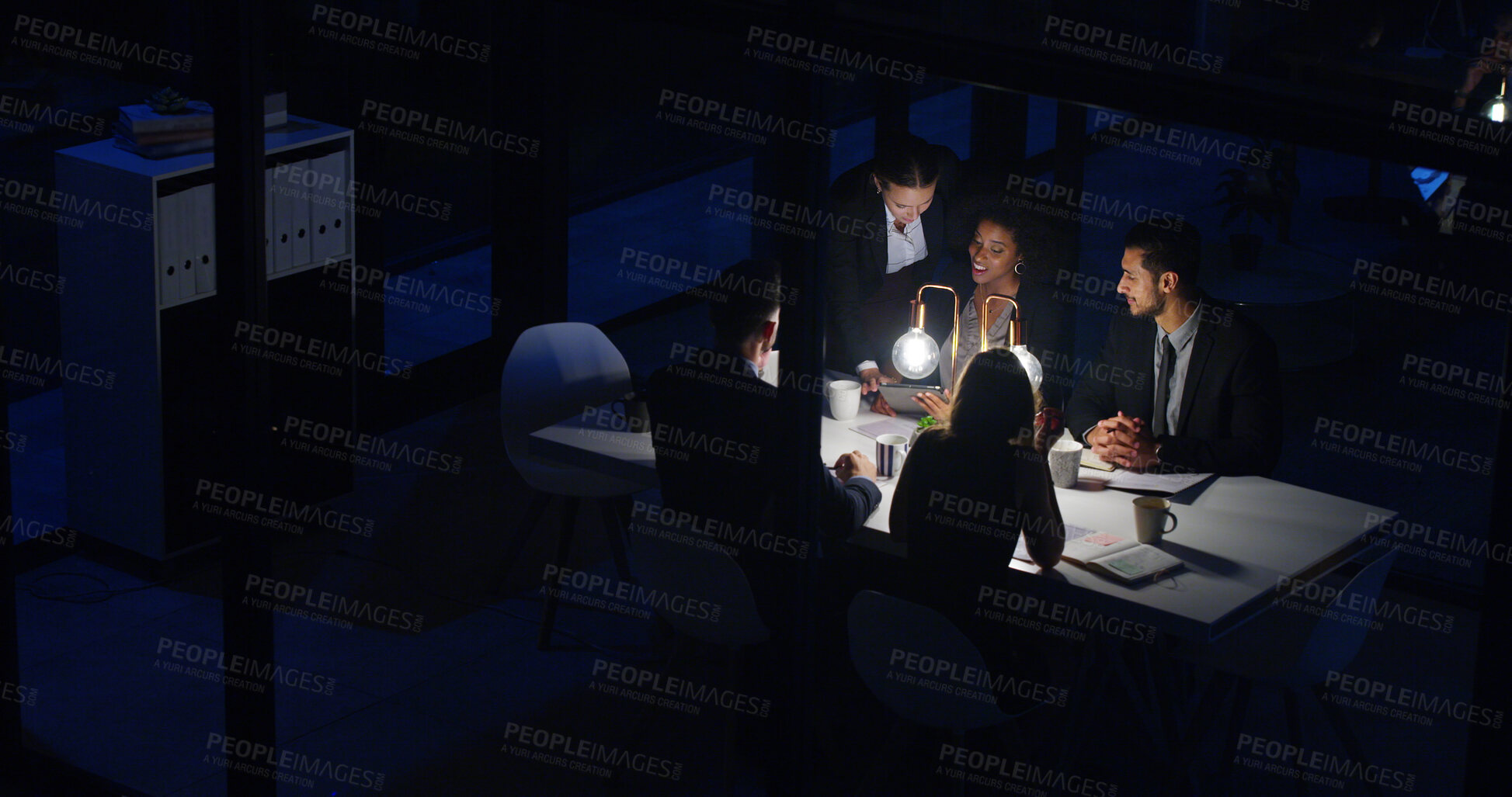 Buy stock photo Teamwork, business people and night meeting for proposal, partnership and collaboration in office. Above, group and overtime conversation in boardroom for strategy, deadline or info with documents
