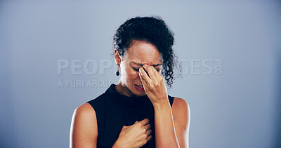 Buy stock photo Woman, sad and crying with emotions in studio for mourning loss, broken heart and bad news. Person, mockup space and grief with depression, mental health and ptsd for trauma memory on gray background