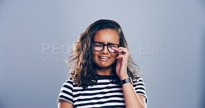 Buy stock photo Sad woman, crying and grief with glasses for breakup, loss or mental breakdown on a studio background. Female person, model or heartbreak with emotional sulk, tears or expression for loneliness
