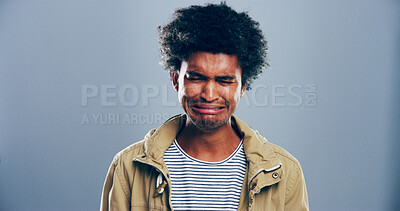 Buy stock photo Sad man, crying or emotional with breakup in studio for mental breakdown or anxiety on a gray background. Male person, expression or sulk eyes with afro, tears or broken heart for loneliness on space