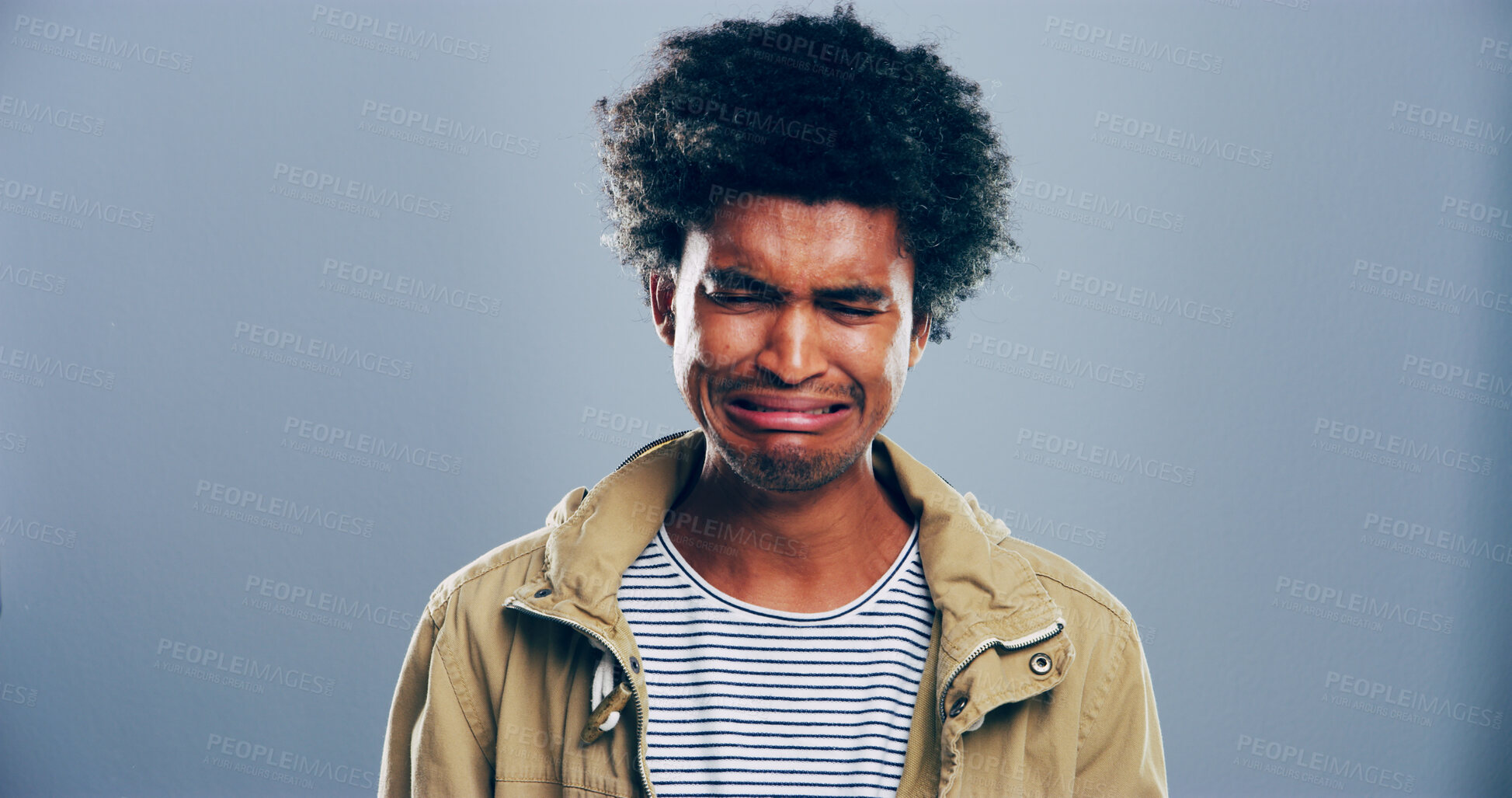 Buy stock photo Sad man, crying or emotional with breakup in studio for mental breakdown or anxiety on a gray background. Male person, expression or sulk eyes with afro, tears or broken heart for loneliness on space