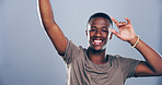 Dance, energy and portrait of black man in studio for celebration, clubbing or party fun. Moving, music and smile of excited African person on gray background mockup for beat, choreography or rhythm