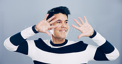 Buy stock photo Creative, expression and mime with man in studio for acting performance, action or theatre arts. Hand gesture, happy and thinking with smile of artist man isolated on gray background for stage drama