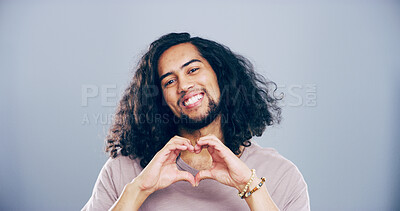 Buy stock photo Happy man, portrait and heart hands with love shape, gesture or romance on grey background space in studio. Student person, smile and emoji or sign, symbol and kindness for valentines day mockup