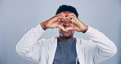 Buy stock photo Happy man, portrait and heart hands with love symbol, gesture or romance on grey background space in studio. African person, smile and emoji or shape, sign and kindness for valentines day mockup