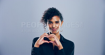 Buy stock photo Heart hands, portrait and smile with flirty woman in studio for affection, love or romance. Emoji, social media and space with African person on gray background mockup for health or wellness gesture