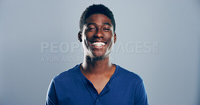 Buy stock photo Fashion, studio and portrait of man, student and excited for scholarship in university, trendy and outfit. Mockup space, grey background and person with clothes, tshirt and guy with smile in Angola