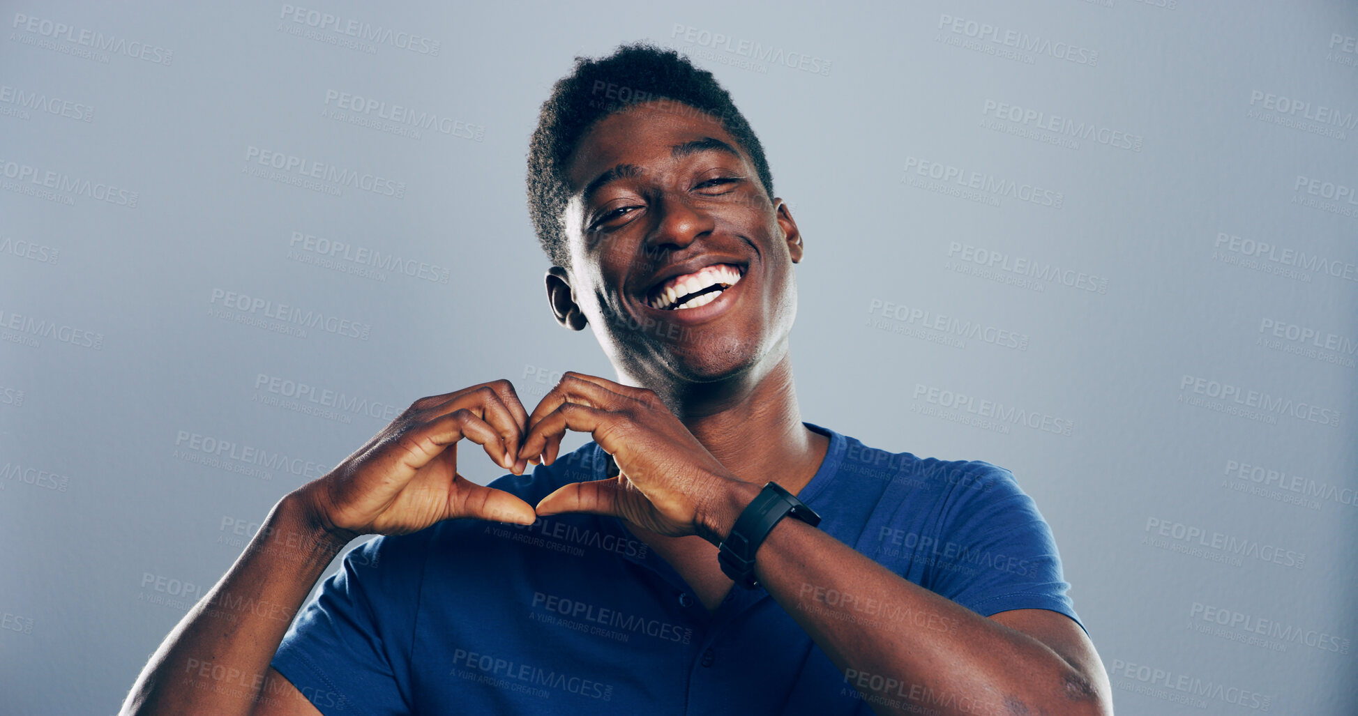 Buy stock photo Heart hands, portrait and smile with happy black man in studio for affection, love or romance. Emoji, flirt and social media with African person on gray background space for health or wellness