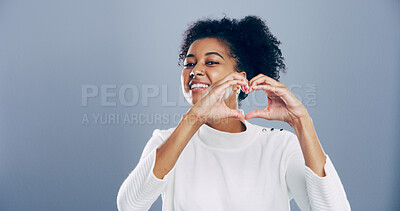 Buy stock photo African student, portrait and heart hands with love emoji, gesture and support on grey background space in studio. Woman, smile and sign or shape, symbol and kindness for valentines day date mockup