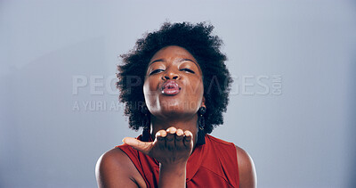 Buy stock photo Pout, woman and blowing kiss in studio, flirting and gesture for romance for valentines day or space. Blue background, mockup and black person with expression for love, happy and portrait of girl