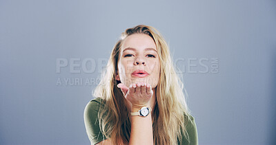 Buy stock photo Flirting, woman and blowing kiss in studio, portrait and gesture for romance for valentines day or space. Blue background, mockup and person with expression for love, happy and girl with pout in USA