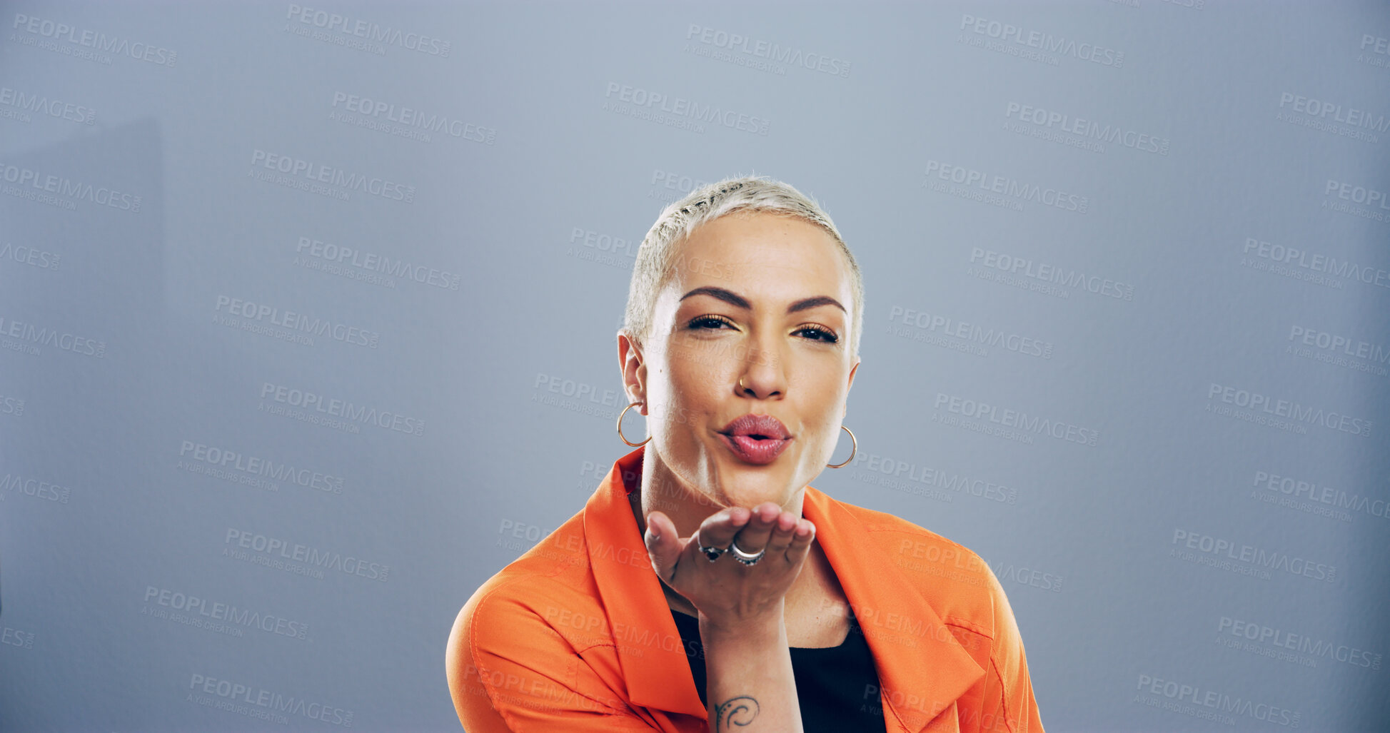 Buy stock photo Portrait, woman and blowing kiss with love for romance, affection or greeting on a gray studio background. Creative, female person or model with gesture or palm for distance or flirt on mockup space