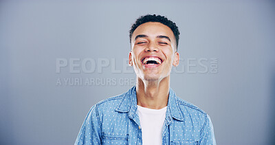 Buy stock photo Face, man and happy for laugh in studio with confidence, joke and good mood on gray background. Space, young model and smile with carefree personality for comedy, humor or funny reaction to meme