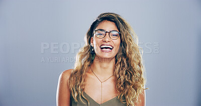Buy stock photo Portrait, glasses and woman laugh in studio for funny joke, comedy or joy isolated on gray background with space. Face, LOL or female person with humor, excited or happy with comic emotion in Brazil