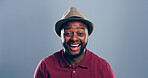 Portrait, black man and laughing in studio for funny joke, comedy and happy with space. Face, smile and African person with humor, excited and lol with comic emotion on gray background with hat