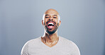 Comedy, man and portrait for laugh in studio with confidence, joke or good mood on gray background. Space, excited model and smile with carefree personality for comic, humor or funny reaction to meme