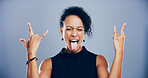Crazy, studio and woman with rock hand gesture or tongue out for expression or heavy metal on gray background. Culture, edgy female rocker or e person with devil horn sign, funky emoji or punk symbol