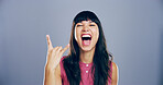 Space, screaming and woman with rock hand gesture in studio for expression or mockup on gray background. Culture, edgy female rocker and crazy girl with devil horn sign, funky emoji and punk symbol