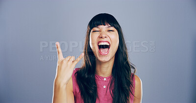 Buy stock photo Space, screaming or woman with rock hand gesture in studio for expression or mockup on gray background. Culture, edgy rocker or portrait of crazy girl with devil horn sign, funky emoji or punk symbol