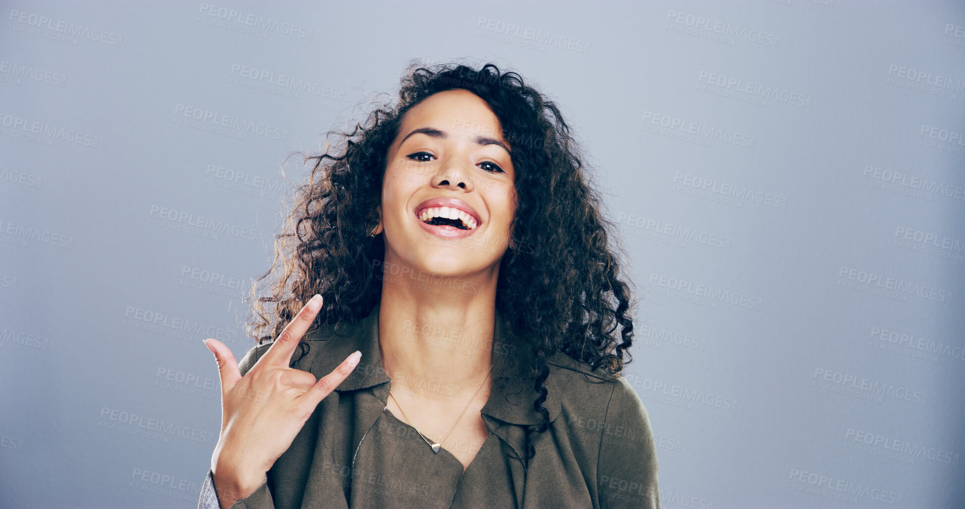 Buy stock photo Portrait, smile and woman in studio with rock hand gesture, expression or space on gray background. Culture, happy female rocker and edgy model with devil horn sign, funky emoji and punk symbol
