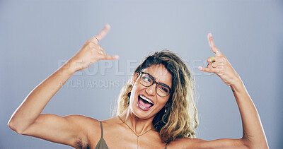 Buy stock photo Portrait, wild and woman with rock hand gesture in studio, expression or space on gray background. Glasses, edgy female rocker and crazy model with devil horn sign, funky emoji or punk culture symbol