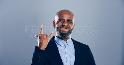 Buy stock photo Studio, portrait and black man with rock hand gesture and tongue out isolated on gray background. Space, edgy rocker and African male person with devil horn sign, funky emoji and wild punk symbol