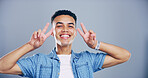 Portrait, casual and happy man with peace sign in studio with positive attitude, confidence or facial expression. Grey background, casual and proud male model for cool gesture, fashion or v symbol