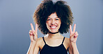 Portrait, peace sign and woman with afro, smile and confidence on blue studio background. Face, person and model with hand gesture, support and icon with symbol, good vibes and emoji with pride 