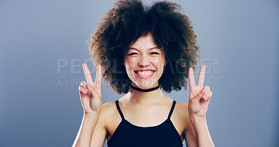 Buy stock photo Portrait, peace sign and woman with afro, smile and confidence on blue studio background. Face, person and model with hand gesture, support and icon with symbol, good vibes and emoji with pride 