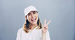 Portrait, peace sign and woman in studio, confidence and good vibes on gray background. Face, person and model with hand gesture, support and agreement with symbol, kindness and emoji with icon