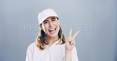 Buy stock photo Portrait, peace sign and woman in studio, confidence and good vibes on gray background. Face, person and model with hand gesture, support and agreement with symbol, mockup space and emoji with icon