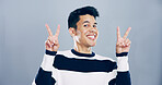 Studio, happy man and portrait with sign for peace, support and motivation for positive feedback. Mockup space, male person and model with hand gesture for v symbol, good mood by gray background