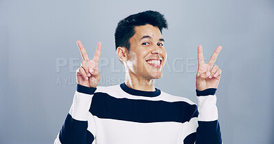 Buy stock photo Studio, happy man and portrait with sign for peace, support and motivation for positive feedback. Mockup space, male person and model with hand gesture for v symbol, good mood by gray background
