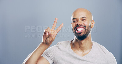 Buy stock photo Studio, black man and portrait with sign for peace, support and motivation for positive feedback. Mockup space, male person and model with hand gesture for v symbol, good mood by gray background