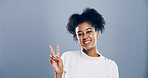 Portrait, peace sign and woman in studio, gesture and confidence on blue background. Face, person and model with kindness, support and emoji with symbol, good vibes and social media with icon