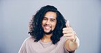 Happy man, portrait or thumbs up with success for winning or approval on a gray studio background. Face, male person or model in joy with smile, like emoji or yes sign for okay, good job or well done