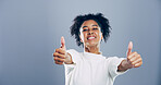 Portrait, thumbs up and woman with agreement, like and confidence on gray studio background. Face, happy person and model with hand gesture, feedback and icon with symbol, perfect and like with emoji
