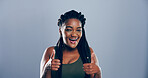 Thumbs up, happy and portrait of black woman in studio with support, agreement or success emoji. Excited, face and African female person with approval or thank you hand gesture by gray background.