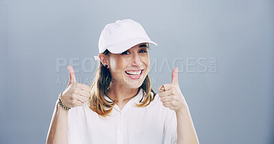 Buy stock photo Thumbs up, smile and portrait of woman in studio with support, agreement or success emoji. Happy, face and female person from Germany with approval or thank you hand gesture by gray background space