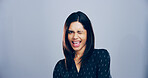 Woman, wink and smile in studio, space and portrait with pride, confident or sign for attitude by background. Person, model and happy with eye icon, emoji or symbol for secret with flirting in Mexico