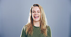 Woman, happy and face with wink in studio portrait, sign or emoji with secret, flirt and joke by background. Person, model and smile with icon, style or eye symbol by space with confidence in Germany
