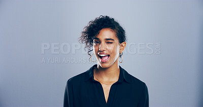 Buy stock photo Girl, wink and space in studio portrait, emoji and flirt with eye symbol by gray background. Person, woman and happy with gesture, playful and secret with trendy fashion, deal and laugh in Costa Rica