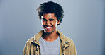 Black man, smile and wink in studio portrait, sign or emoji for secret, flirting and afro by background. Person, model and happy with icon, style and face for eye symbol by space with pride in USA