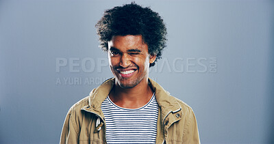 Buy stock photo Man, smile and wink in studio with portrait, sign or emoji for secret, flirting and afro by gray background. Person, model and happy with icon, style or face for eye symbol by space with pride in USA
