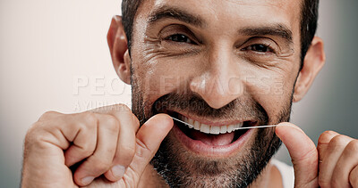 Buy stock photo Teeth, smile and man in portrait with dental floss for oral hygiene, cleaning plaque and gum health. Routine, person or mouth care on studio background for fresh breath, grooming or cavity prevention