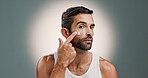 Skincare, cream application and portrait of man in studio for wellness, health and facial hydration. Dermatology, beauty and person with lotion, moisturizer and cosmetics on gradient background