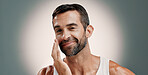 Skincare, face cream and portrait of happy man in studio for wellness, health and facial hydration. Dermatology, beauty and person smile with lotion, moisturizer and cosmetics on gradient background