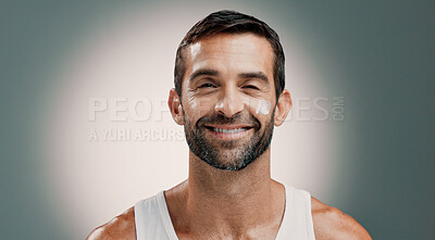 Buy stock photo Happy, face cream and portrait of man for skincare wellness, health and hydration for facial treatment. Dermatology, beauty and person with lotion, moisturizer and cosmetics on studio background